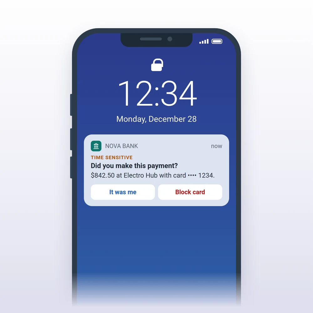 Time-Sensitive push from a bank asking to confirm a card payment, with It was me and Block card buttons, on an iPhone lock screen